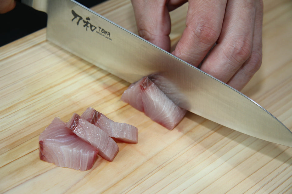 三徳包丁で骨を除いた魚の身を切り分ける手元